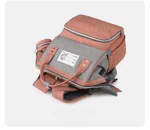 Macro view of multi-functional diaper bag with clear ID card slot and metal zipper details