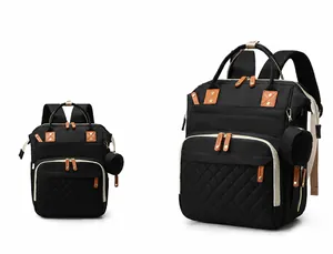 Front view of black quilted multi-functional diaper backpack with gold hardware and side pouch