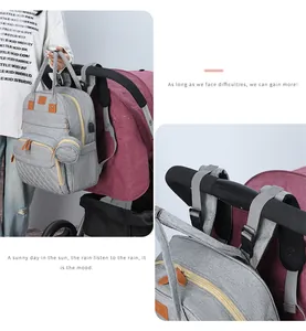 Detail showing the gray multi-functional diaper bag hanging on a stroller handlebar