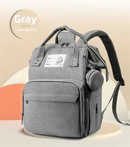 Grey multi-functional diaper backpack featuring reinforced handles and small side coin purse