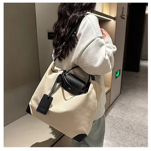 Close-up of canvas travel bag with black leather straps and NOOO brand tag details