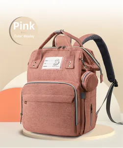 Detail of pink diaper backpack with breathable mesh straps and detachable coin purse accessory