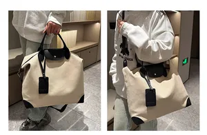 Detail of canvas travel bag featuring black leather handles and NOOC brand tag