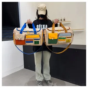 Detail of color-block travel bag featuring functional pockets and webbing handles