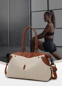 Close-up of large canvas travel bag with leather handles and durable interior pockets