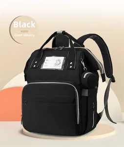 Detail of multi-functional black baby diaper bag showing top handles and breathable straps