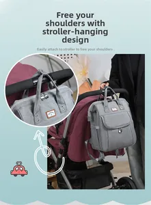 Detail of grey baby diaper backpack attached to stroller handles for hands-free convenience