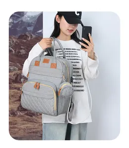 Detail of multi-functional diaper backpack showing external USB port and phone charging