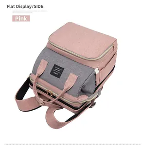 Pink and grey diaper backpack with padded shoulder straps and multiple zipper compartments