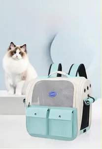 Detail of mint green pet carrier backpack featuring breathable mesh and storage pockets