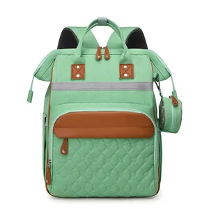 Multifunctional mint green diaper backpack with quilted heart pattern and leather accents