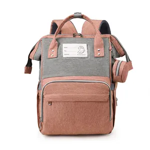 Pink and grey large capacity mommy backpack with padded straps and small round pouch