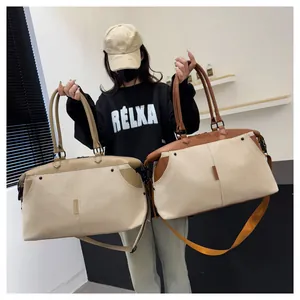 Detail showing dual color options for the large canvas travel bag with leather handles
