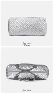 Top and bottom views of silver quilted travel bag showing zipper and textured fabric