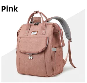 Detailed macro view of the pink diaper backpack showing its fabric texture and zippers