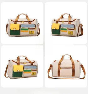 Detail view of large beige and brown travel bag with multiple zipper compartments