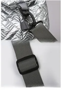 Detail of adjustable nylon strap and secure swivel hooks on silver quilted travel bag