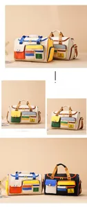 Detail of color-block travel bag featuring multi-pocket storage and durable canvas fabric