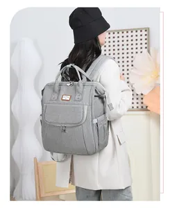 Practical grey large-capacity diaper backpack with front pocket shown in modern interior