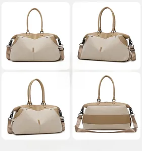 Detail of khaki canvas travel bag showing back luggage strap and adjustable shoulder strap
