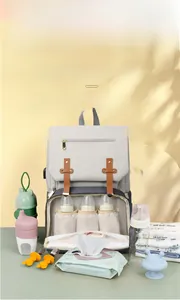 Detail of gray baby diaper bag featuring three insulated milk bottle compartments