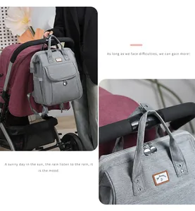 Detail of grey diaper bag with My Sunshine label and straps for stroller attachment