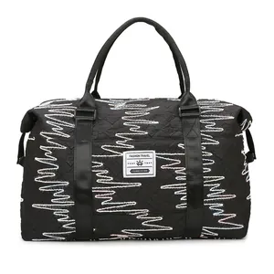 Quilted black travel bag with colorful embroidery and large capacity for gym or sport