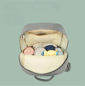 Internal view of a grey diaper bag showing multiple compartments and large capacity