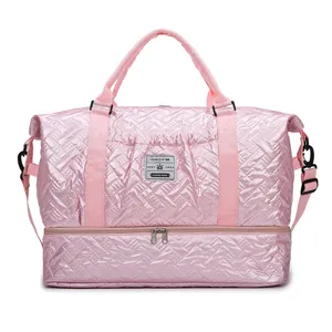 Pink quilted travel bag with shoe compartment and detachable shoulder strap for gym and sports