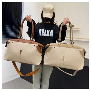 Detail of durable canvas travel bag with leather accents and adjustable shoulder straps