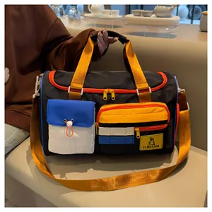 Macro detail of multi-pocket travel bag showing blue flap and yellow zipper compartment