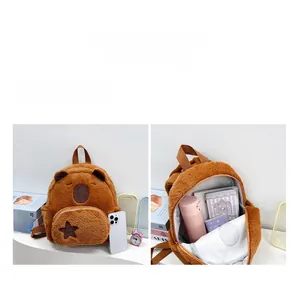 Detail of Capybara plush backpack showing internal large capacity and phone scale