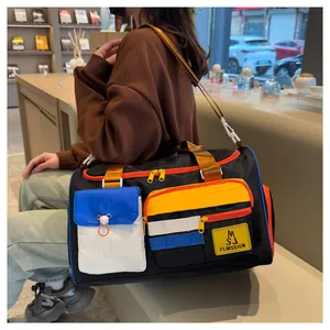 Close-up of contrast color travel bag showing blue and red pockets on durable fabric