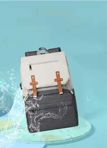 Detail shot of waterproof material on dual-tone gray diaper bag with splash effect