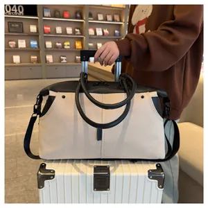 Detail of canvas travel bag featuring trolley sleeve for easy suitcase attachment