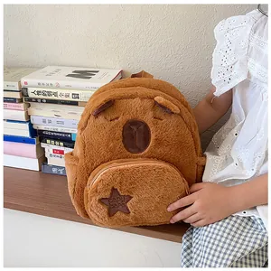 Detailed macro of the plush capybara backpack featuring soft fur and star embroidery