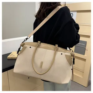 Close-up of durable canvas travel bag with leather trim and adjustable shoulder strap