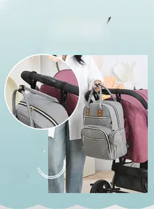 Gray diaper bag backpack with stroller hooks design for easy attachment to baby carriages
