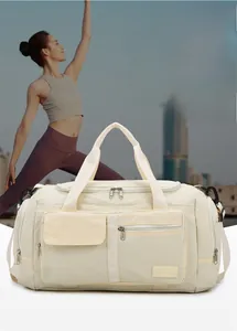 Close-up of beige travel fitness bag with durable oxford fabric and multiple zip pockets