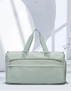 Detail view of the mint green travel bag featuring durable waterproof fabric and metal hooks