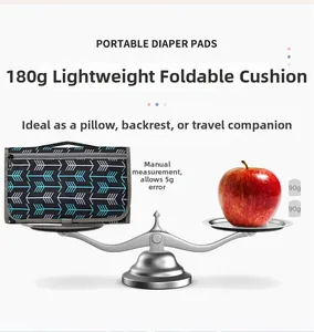 Portable 180g diaper pad folded into a compact cushion with blue and white arrows