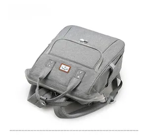 Top-down view of gray diaper backpack featuring durable fabric and reinforced handles