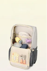 Detail showing wide opening and multi-functional inner compartments of the diaper bag
