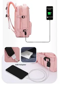 Pink travel backpack detail featuring external USB charging port and side buckle closure