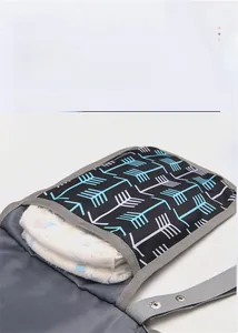 Detail showing inner storage of portable waterproof diaper bag with white diapers