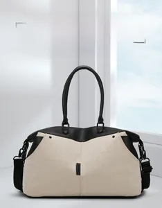 Detail of high-capacity canvas fitness bag with reinforced black leather handles