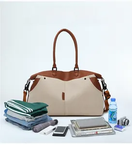 Detailed shot of beige canvas and brown leather travel bag with various packing essentials