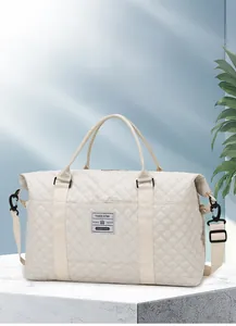 Detail of quilted beige travel bag with large capacity for gym and yoga sessions