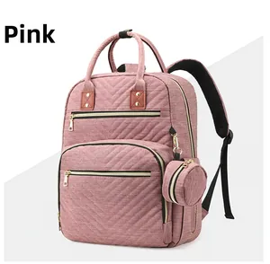 Pink quilted diaper backpack with large capacity and matching round coin purse detail