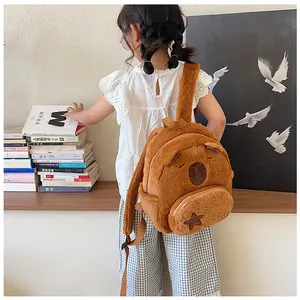 Detail of cute brown plush capybara backpack showing soft fur texture and nylon straps